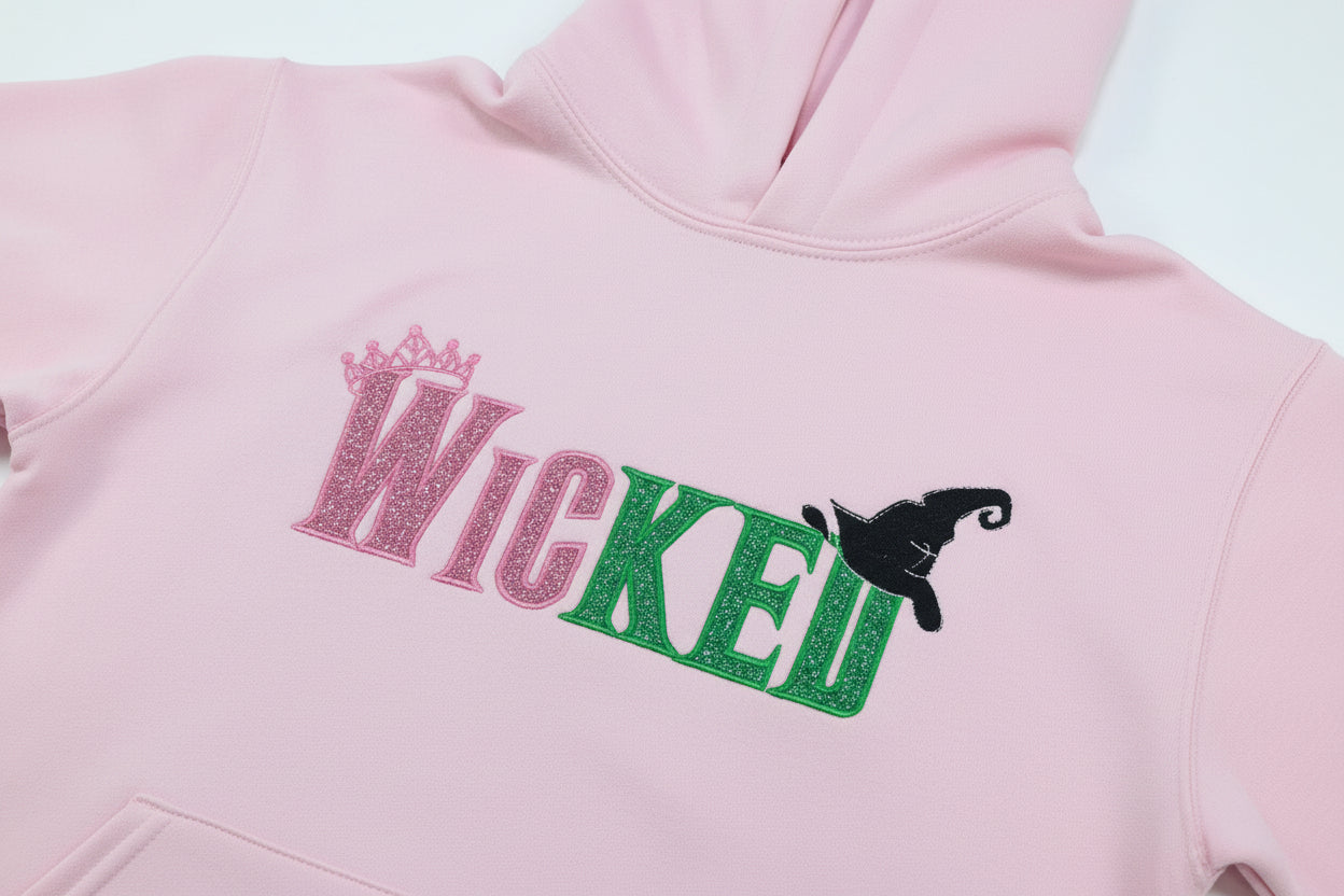 Youth WICKED! This sparkly, Wicked embroidered sweatshirt is perfect for Youth. Complete with sleeve embellishment Broom and Wand Vinyl