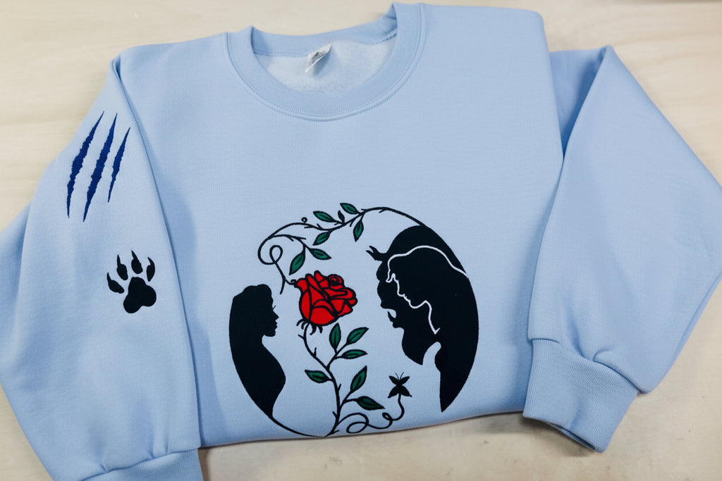 Beauty and the Beast. Cozy embroidered Sweatshirt with sleeve embellishments. A Disney classic fairytale. Featuring the famous Rose.