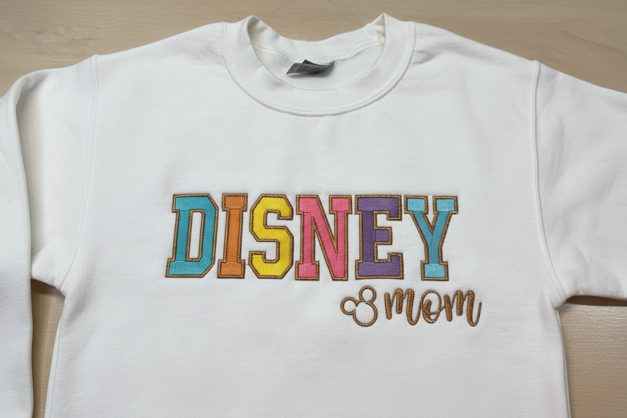 Soft and Comfy Disney Mom Embroidered Sweatshirt with Vibrant colors outlined in a Metallic Golden Thread.