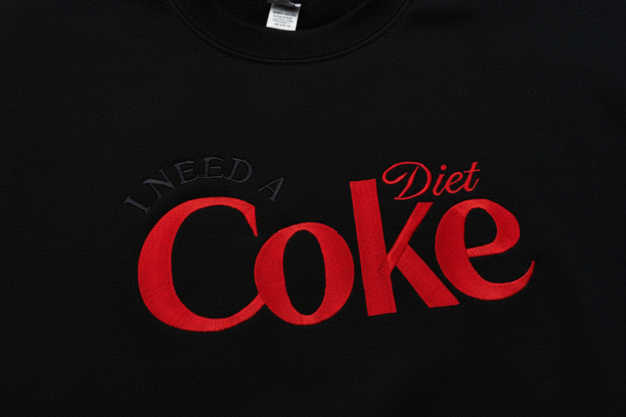 Diet Coke fans. I need a Diet Coke embroidered cozy sweatshirt comes with a mini sized Diet Coke on the sleeve.