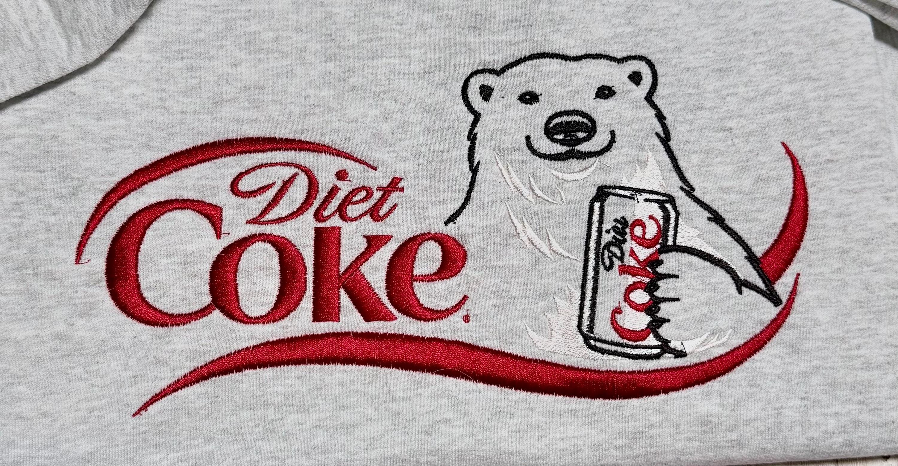 I need a Diet Coke polar bear embroidered cozy sweatshirt comes with a mini sized Diet Coke on the sleeve.
