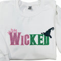 WICKED! This sparkly, embroidered wicked sweatshirt is perfect for Wicked fans. Includes a sleeve embellishment of a Green Broom/Pink Wand