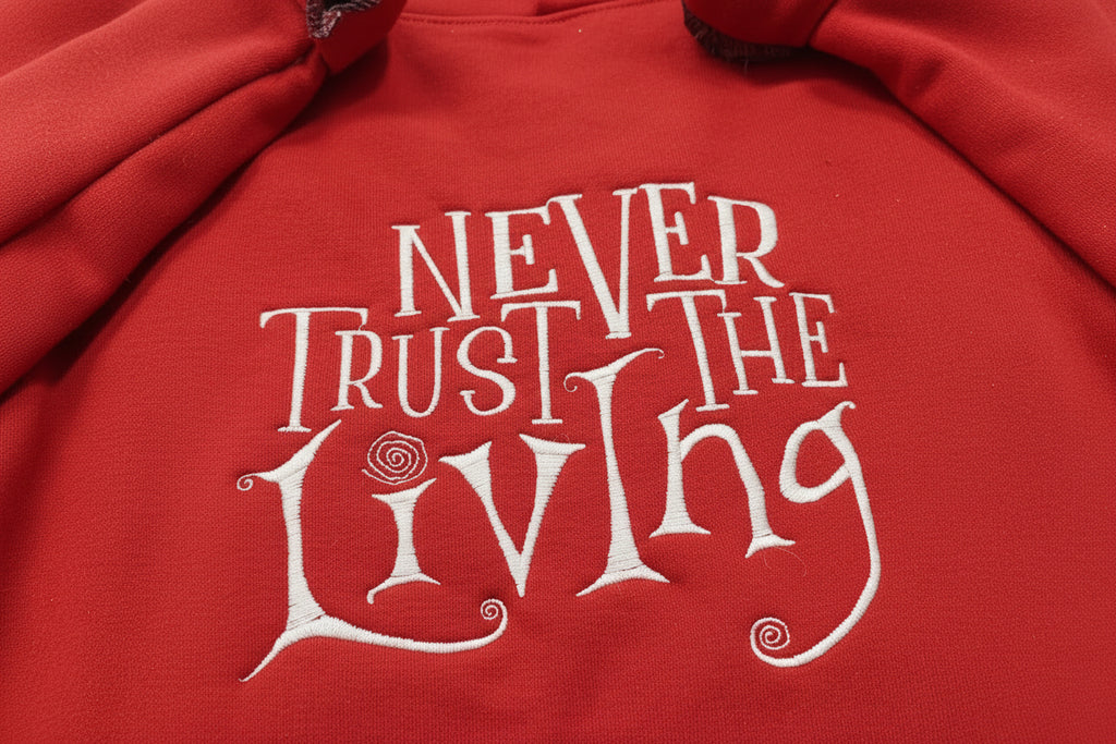 Coraline “Never Trust The Living” Season Embroidered Sweatshirt. Keeps you warm and cozy for those chilly nights.
