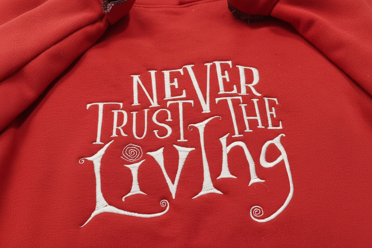 Coraline “Never Trust The Living” Season Embroidered Sweatshirt. Keeps you warm and cozy for those chilly nights.