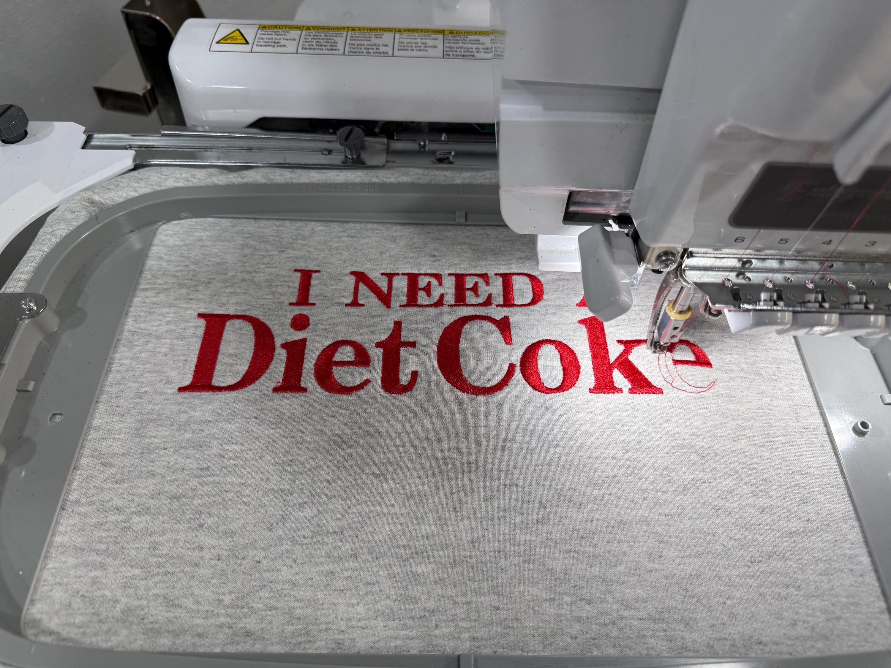 Diet Coke fans. I need a Diet Coke embroidered cozy sweatshirt comes with a mini sized Diet Coke on the sleeve.