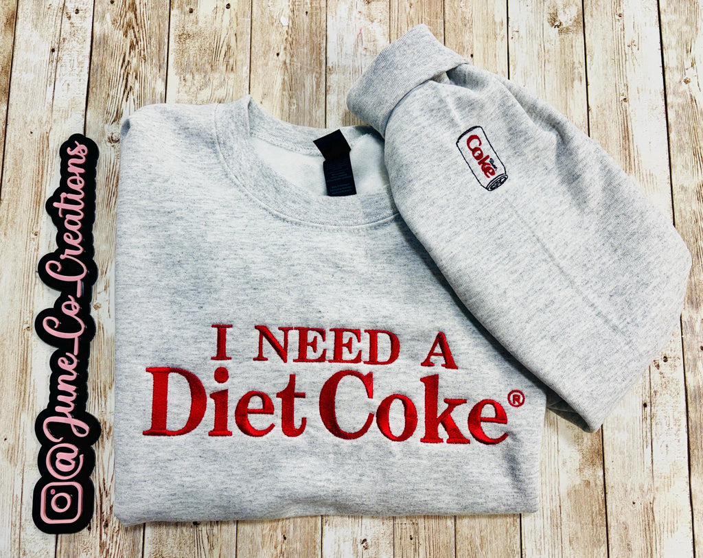 Diet Coke fans. I need a Diet Coke embroidered cozy sweatshirt comes with a mini sized Diet Coke on the sleeve.