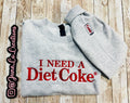 Diet Coke fans. I need a Diet Coke embroidered cozy sweatshirt comes with a mini sized Diet Coke on the sleeve.