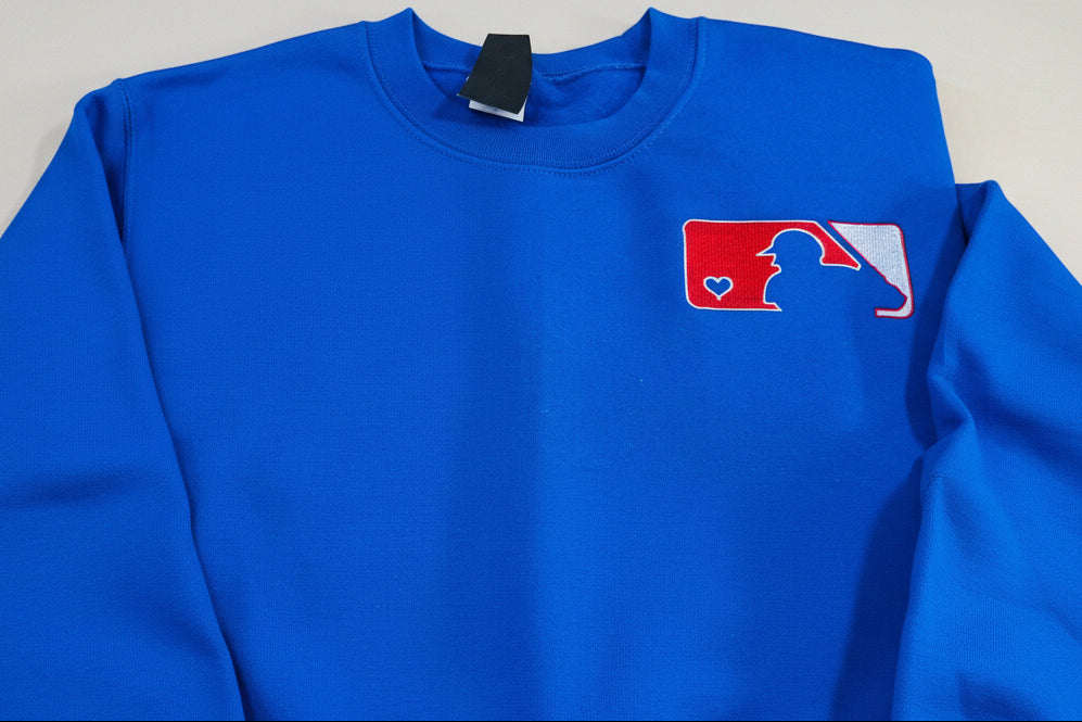 Love of Baseball Embroidered Sweatshirt. Classic outline of a baseball player and a heart logo is embroidered onto a soft & cozy sweatshirt.