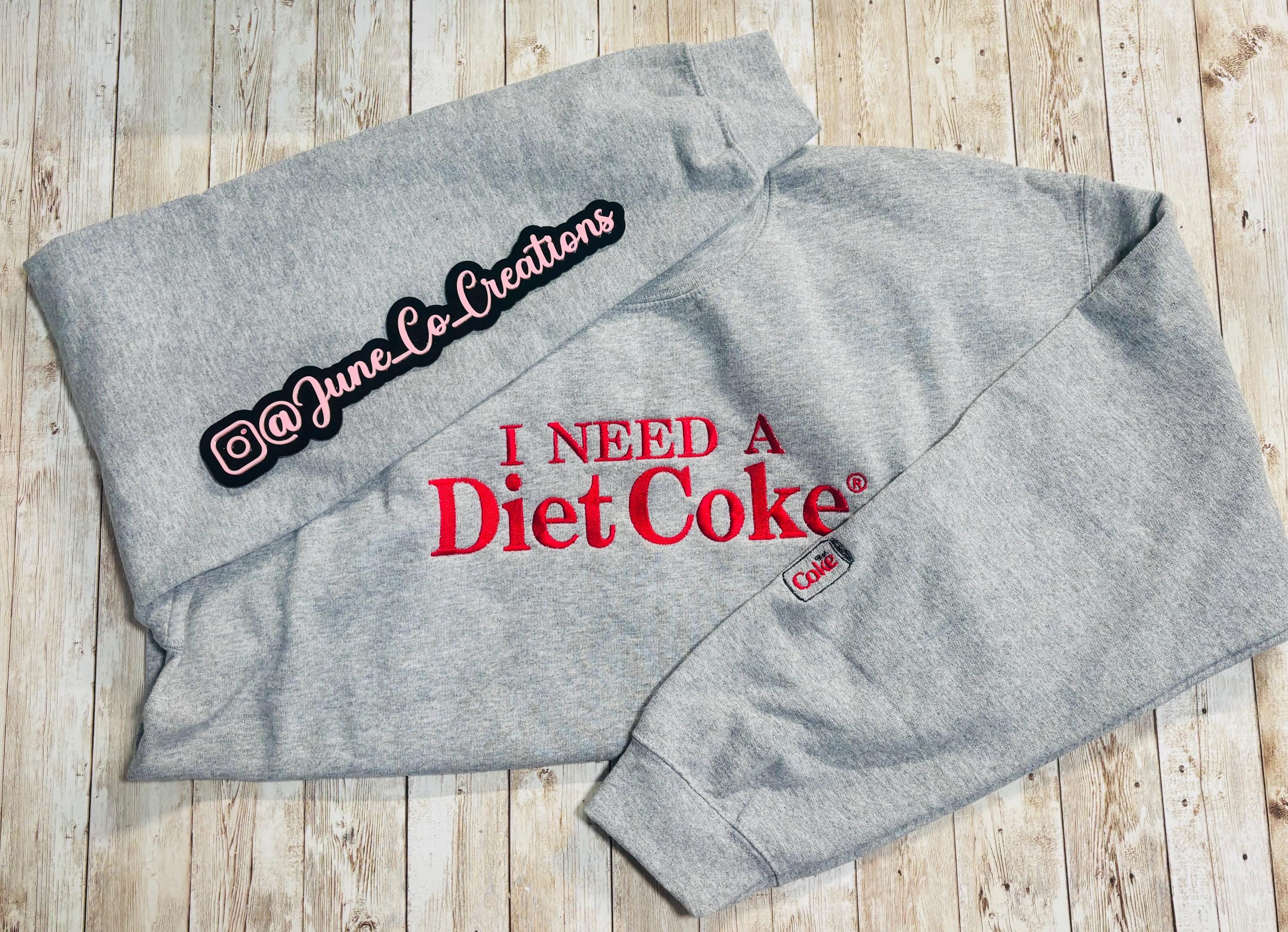 I need a Diet Coke embroidered sweatshirt. Cozy sweatshirt with a mini Diet Coke embellishment on the sleeve
