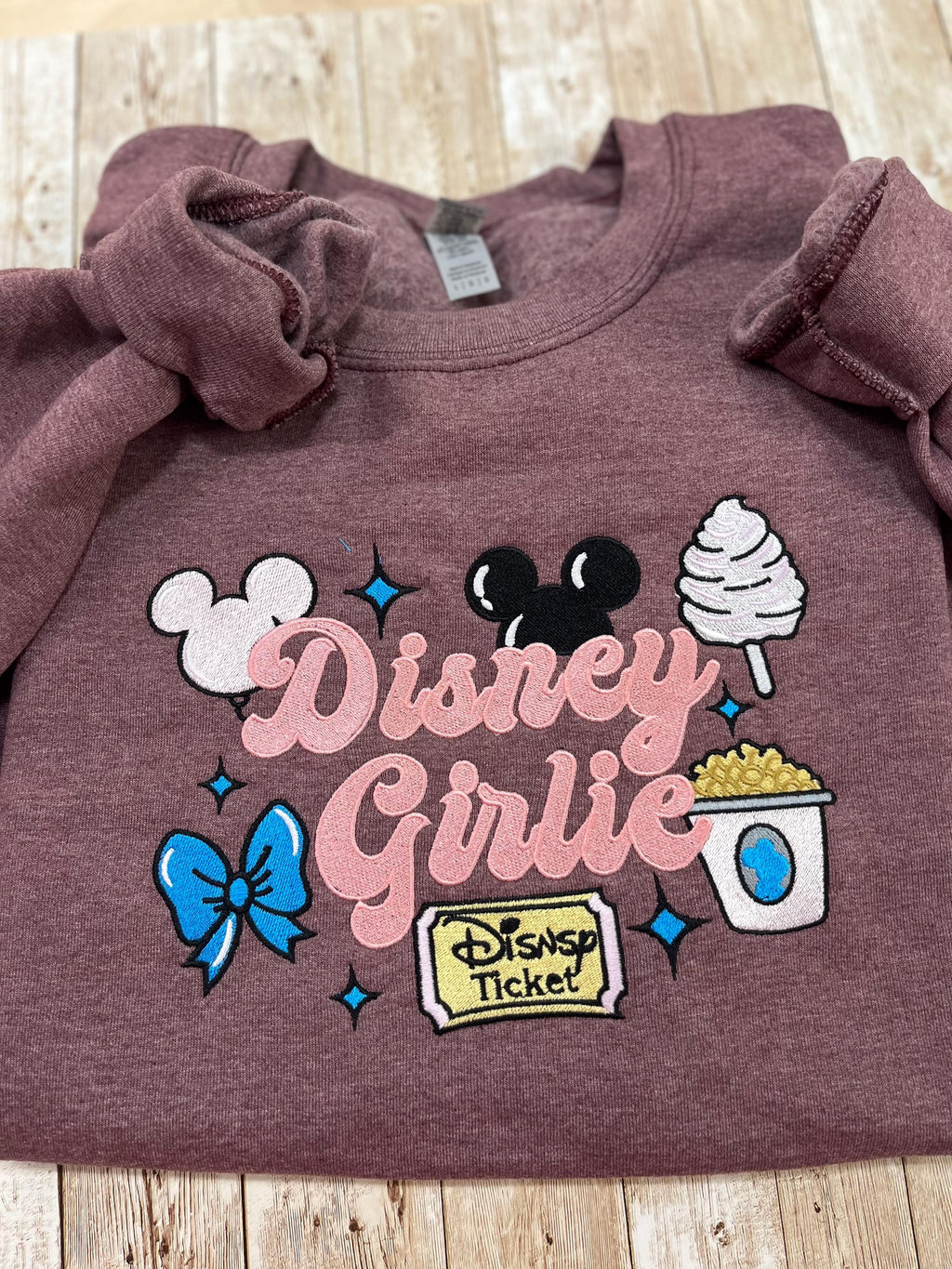 Disney girlie. Cozy embroidered Sweatshirt with sleeve embellishments. Featuring Disney classic icons. All the things you love Disney.