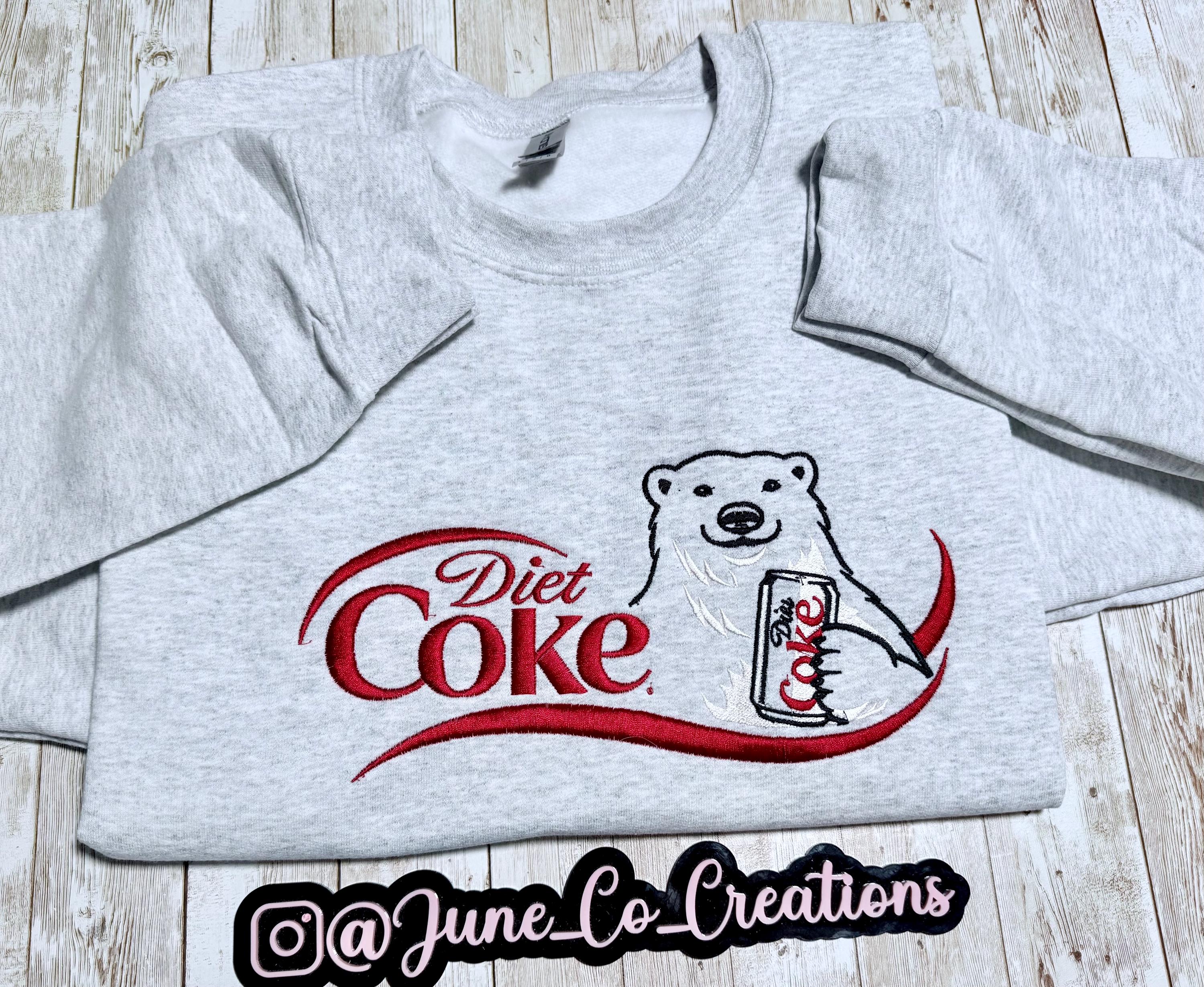 I need a Diet Coke polar bear embroidered cozy sweatshirt comes with a mini sized Diet Coke on the sleeve.