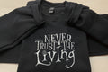 Coraline “Never Trust The Living” Season Embroidered Sweatshirt. Keeps you warm and cozy for those chilly nights.