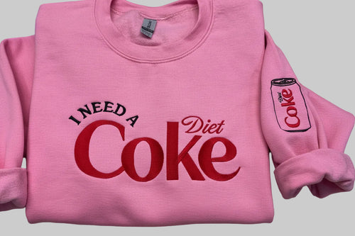 Diet Coke fans. I need a Diet Coke embroidered cozy sweatshirt comes with a mini sized Diet Coke on the sleeve.