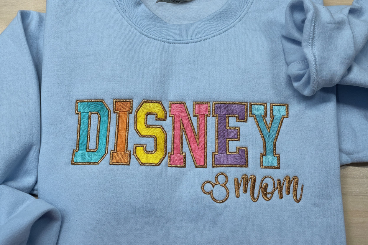 Soft and Comfy Disney Mom Embroidered Sweatshirt with Vibrant colors outlined in a Metallic Golden Thread.