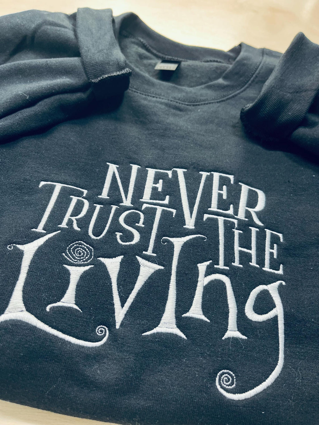 Coraline Embroidered Sweatshirt: "Never Trust The Living" Fall Apparel