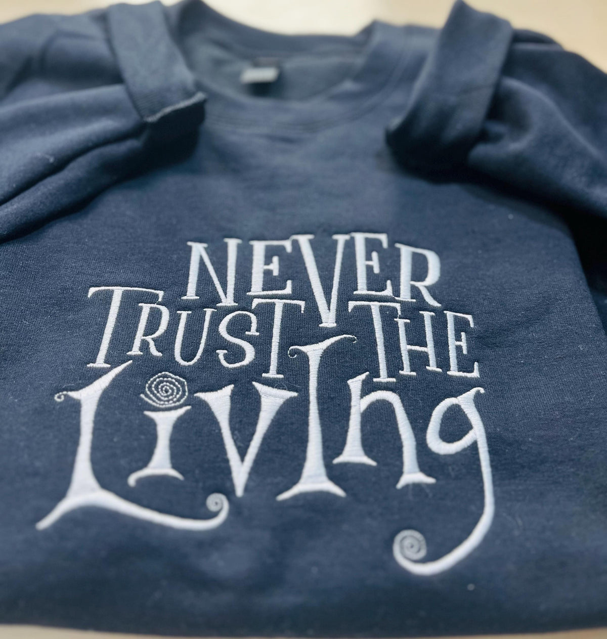 Coraline Embroidered Sweatshirt: "Never Trust The Living" Fall Apparel