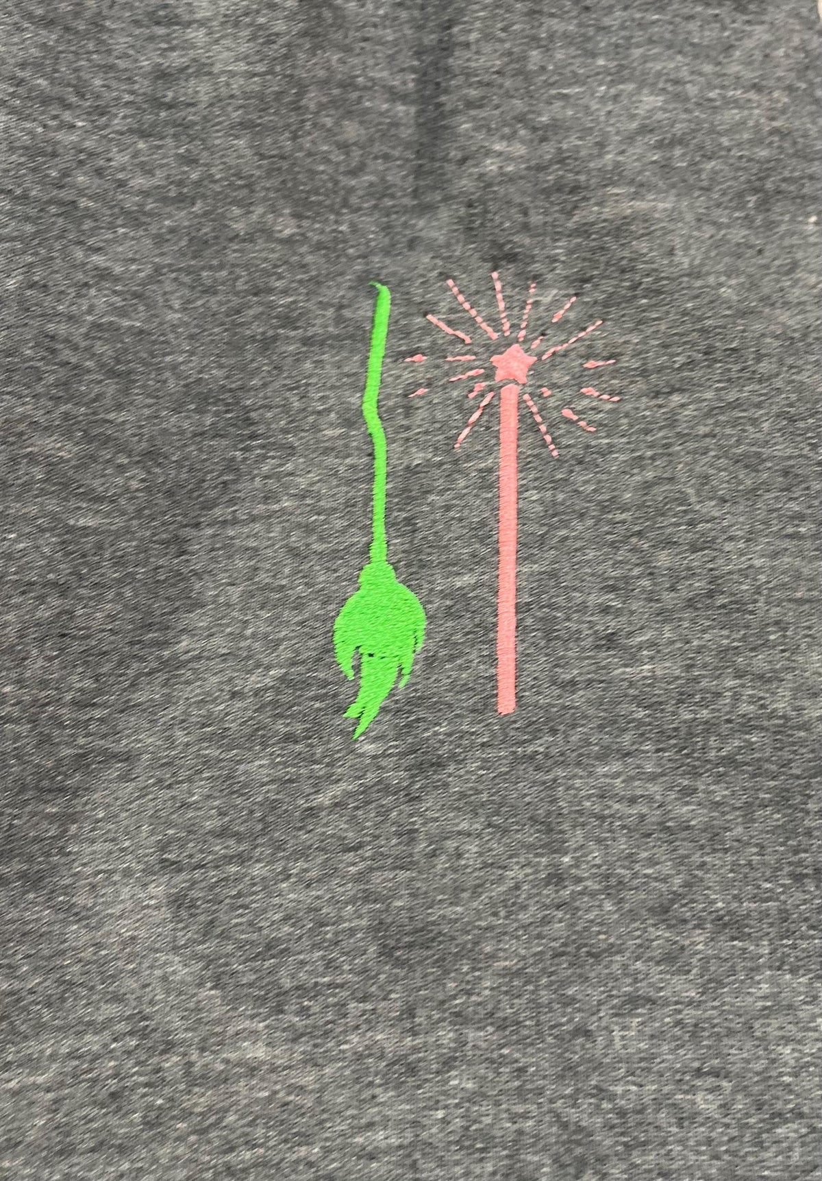 WICKED! This sparkly, embroidered wicked sweatshirt is perfect for Wicked fans. Includes a sleeve embellishment of a Green Broom/Pink Wand