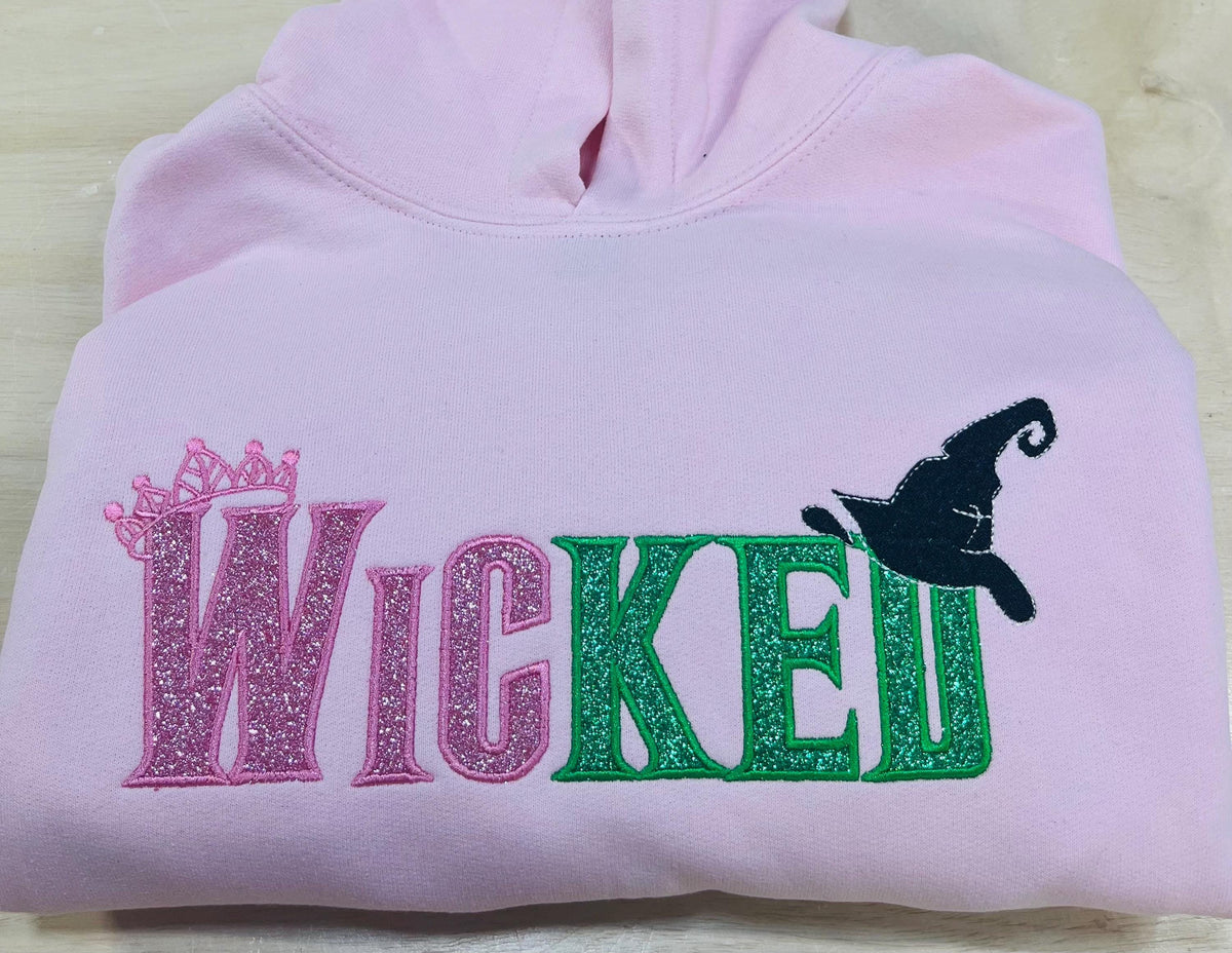 Youth WICKED! This sparkly, Wicked embroidered sweatshirt is perfect for Youth. Complete with sleeve embellishment Broom and Wand Vinyl