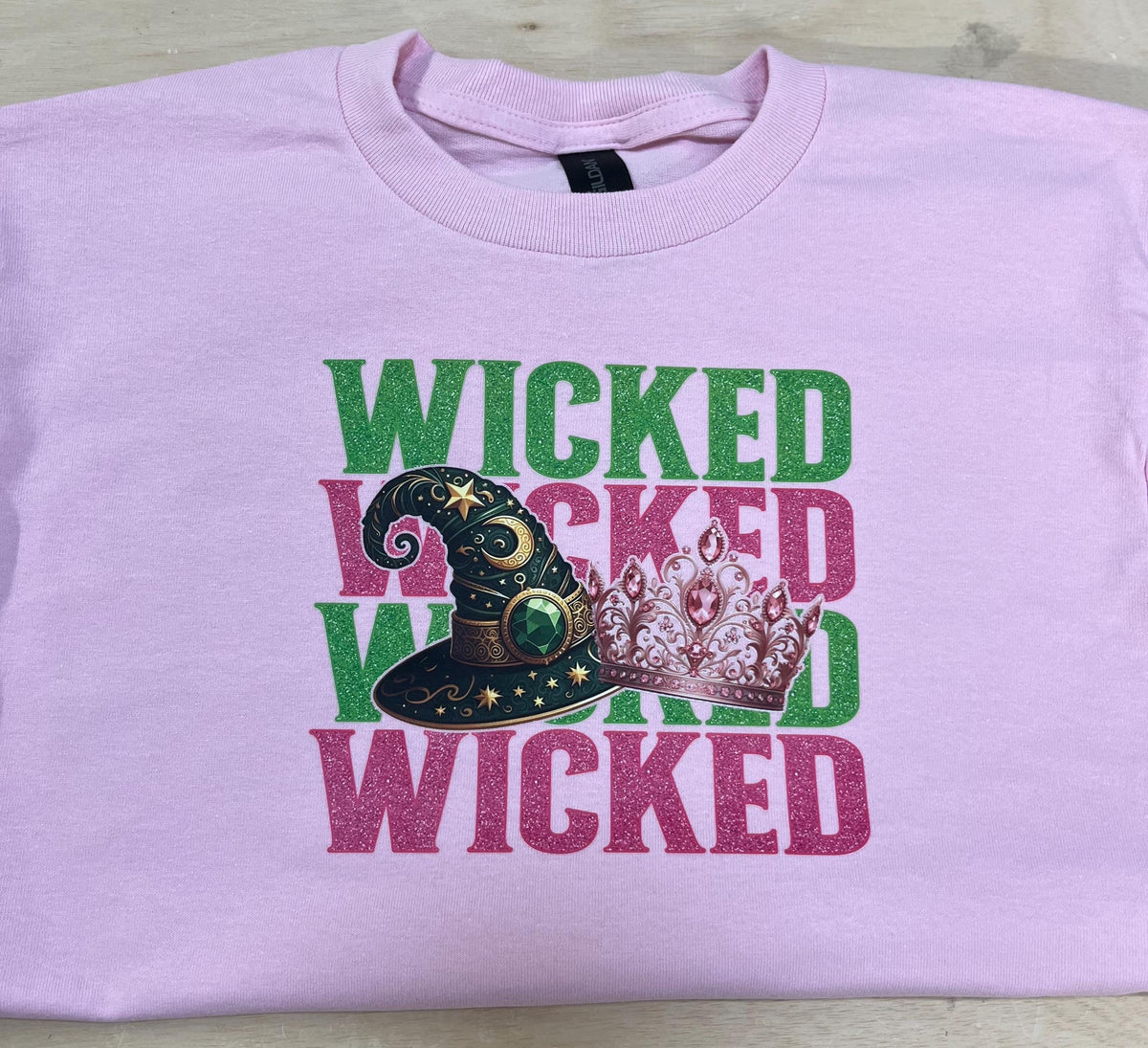 Youth WICKED! This sparkly, Wicked iron on T-Shirt is perfect for Youth. Complete with sleeve embellishment Broom and Wand Vinyl