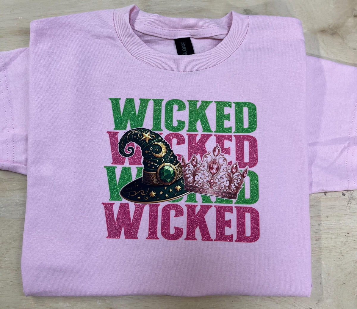 Youth WICKED! This sparkly, Wicked iron on T-Shirt is perfect for Youth. Complete with sleeve embellishment Broom and Wand Vinyl