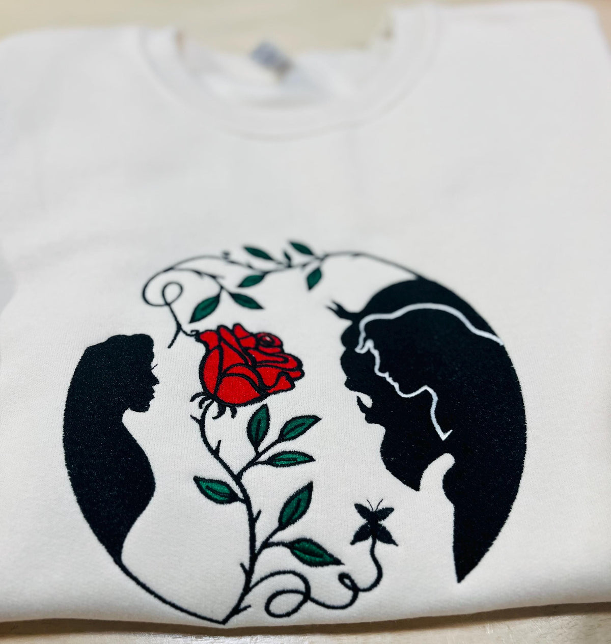 Beauty and the Beast. Cozy embroidered Sweatshirt with sleeve embellishments. A Disney classic fairytale. Featuring the famous Rose.