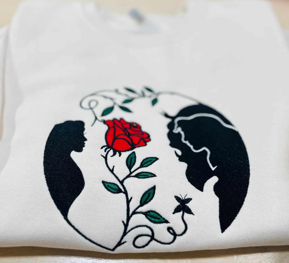 Beauty and the Beast. Cozy embroidered Sweatshirt with sleeve embellishments. A Disney classic fairytale. Featuring the famous Rose.