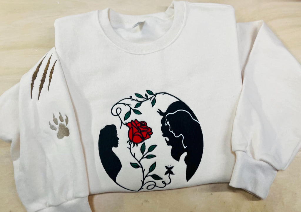 Beauty and the Beast. Cozy embroidered Sweatshirt with sleeve embellishments. A Disney classic fairytale. Featuring the famous Rose.
