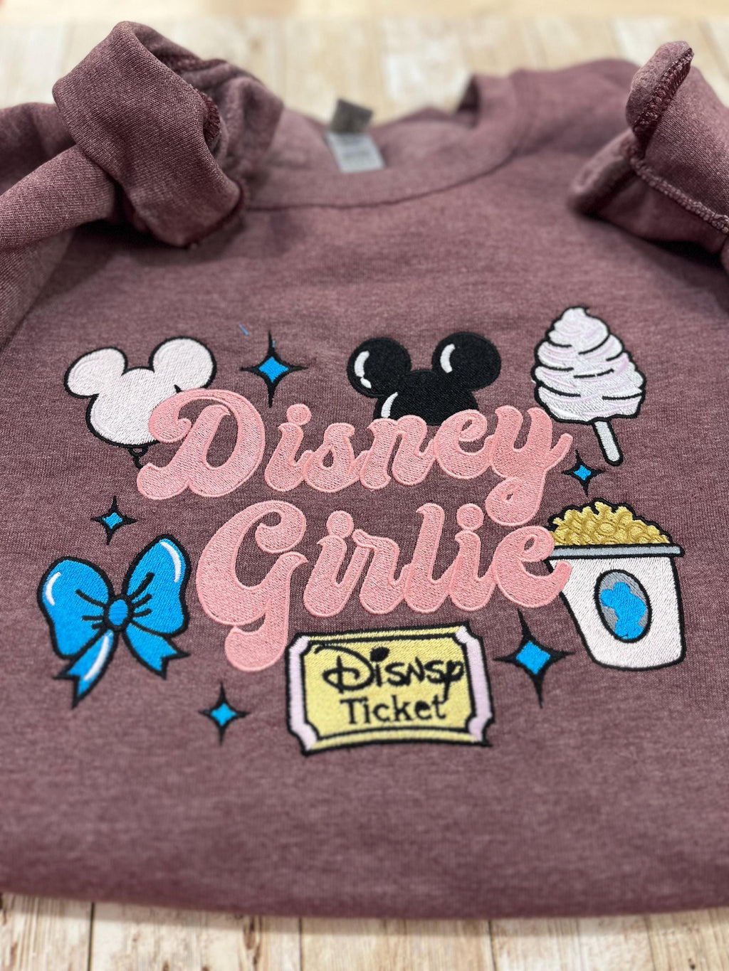 Disney girlie. Cozy embroidered Sweatshirt with sleeve embellishments. Featuring Disney classic icons. All the things you love Disney.