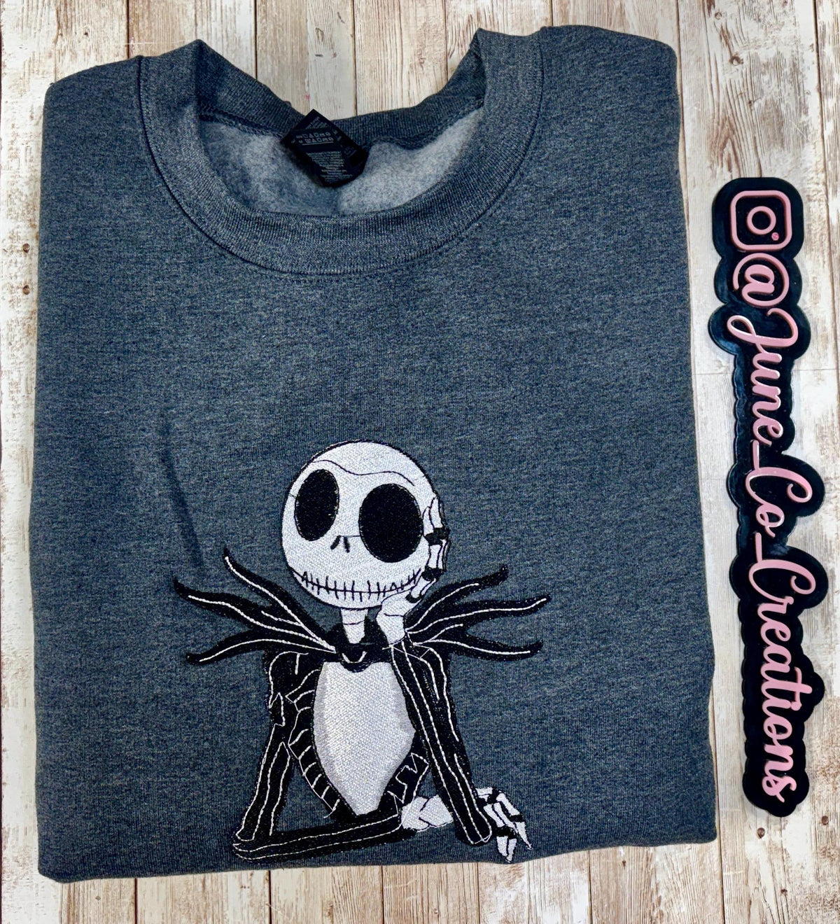 Celebrate the season with our cozy embroidered sweatshirt featuring Jack Skellington!