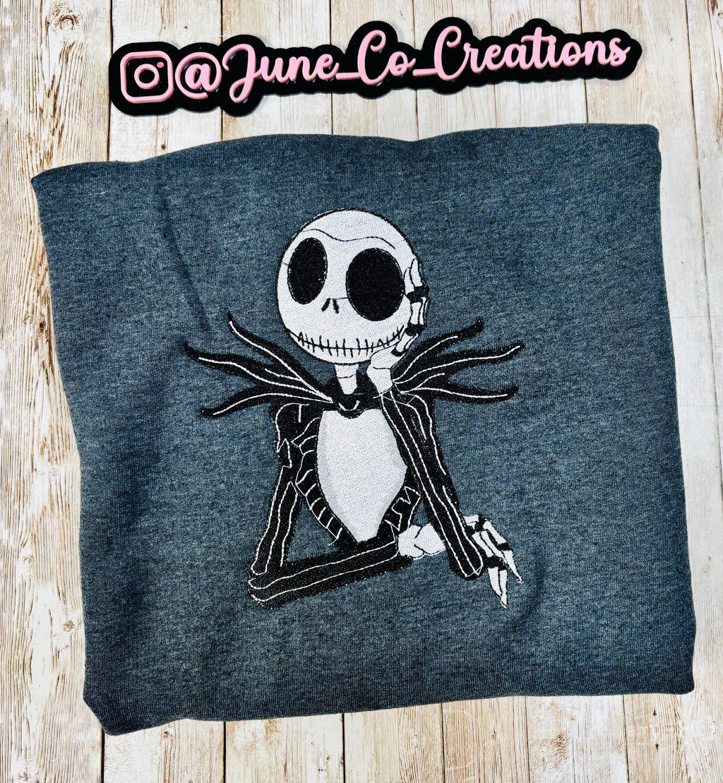 Celebrate the season with our cozy embroidered sweatshirt featuring Jack Skellington!