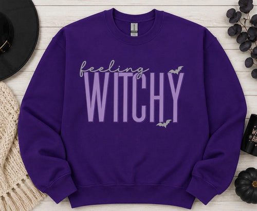 Celebrate the season with our cozy embroidered sweatshirt featuring “Feeling Witchy” embellished with some bats