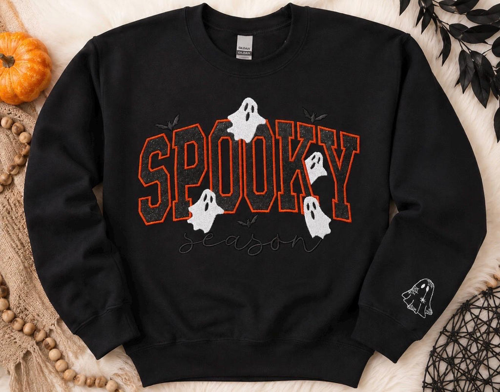 Spooky Season sparkly with our cozy embroidered sweatshirt featuring “spooky” embellished with some bats and ghosts.