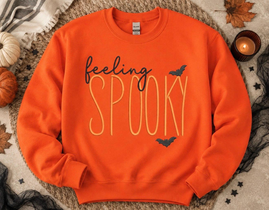 Celebrate the season with our cozy embroidered sweatshirt featuring “ feeling spooky” embellished with some bats