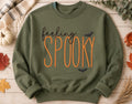 Celebrate the season with our cozy embroidered sweatshirt featuring “ feeling spooky” embellished with some bats