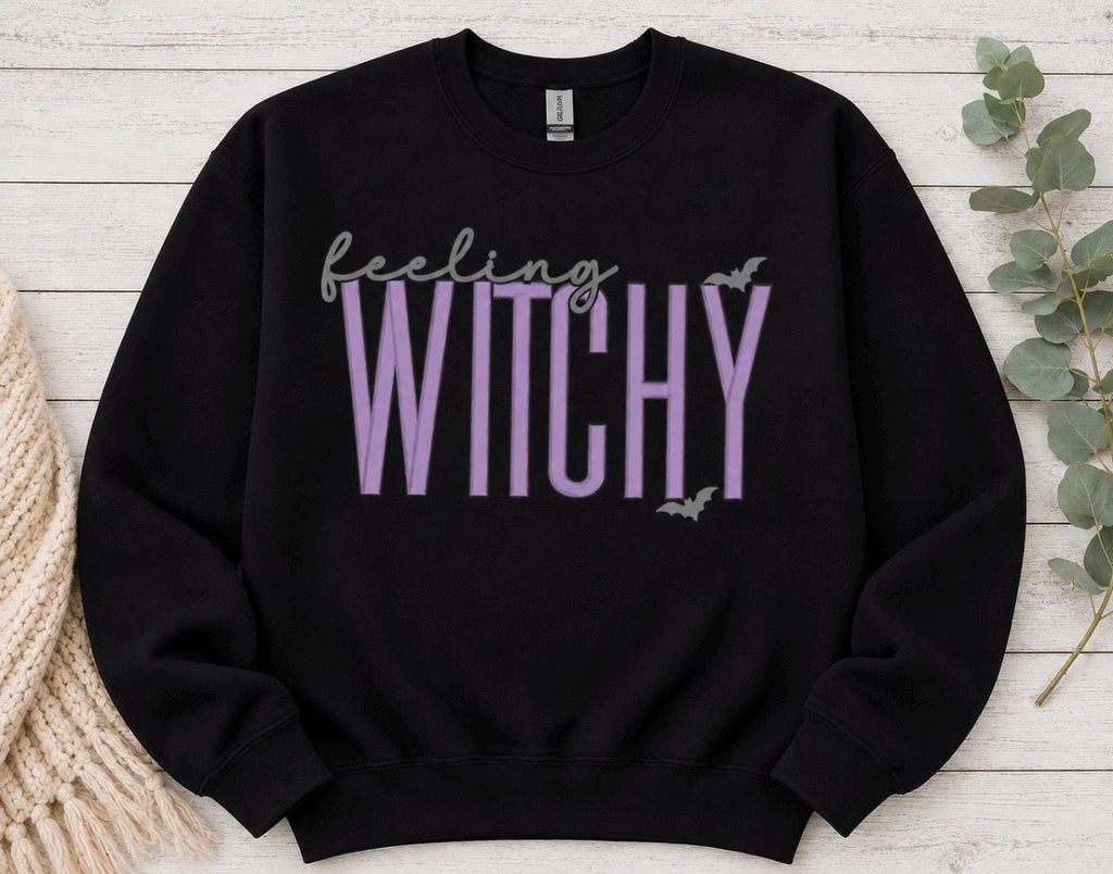 Celebrate the season with our cozy embroidered sweatshirt featuring “Feeling Witchy” embellished with some bats