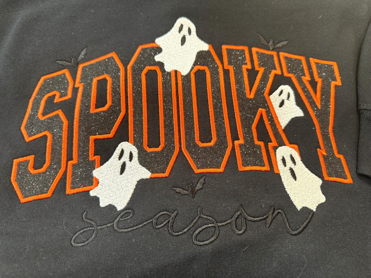 Spooky Season sparkly with our cozy embroidered sweatshirt featuring “spooky” embellished with some bats and ghosts.