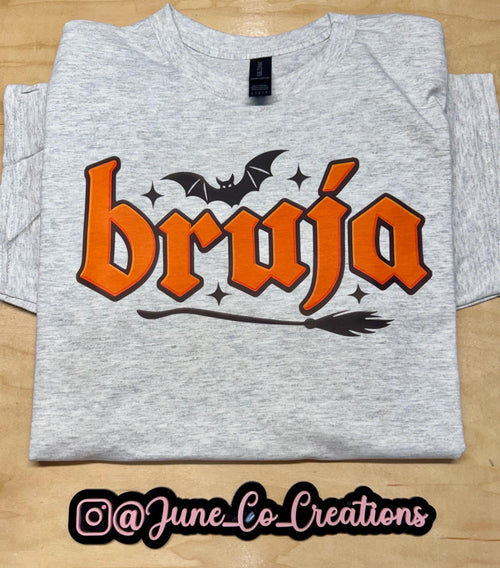 Bruja “Witch” spooky season tshirt. Broom and Bats this made to order tshirt is perfect for fall.